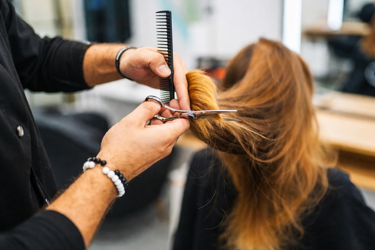 Фризьор по време на подстригване в салон за красота – символ на професионалния бранш и нуждата от модерни правила