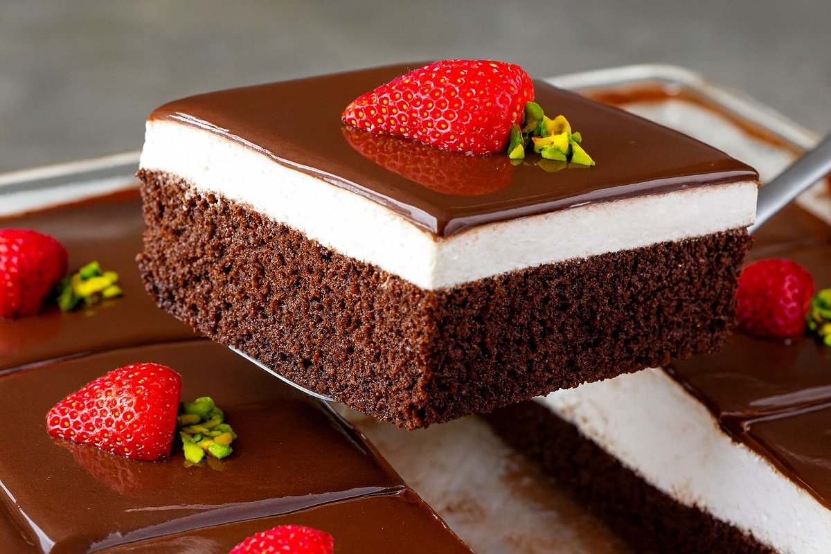 Сочна аглаян паста с шоколадов блат, млечен крем и лъскав шоколадов сос, украсена с ягоди и шамфъстък